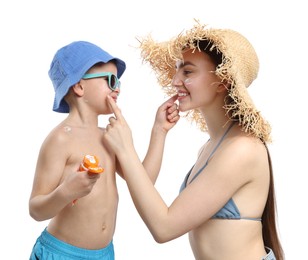 Photo of Mother and her son applying sun protection cream onto each other's skin on white background
