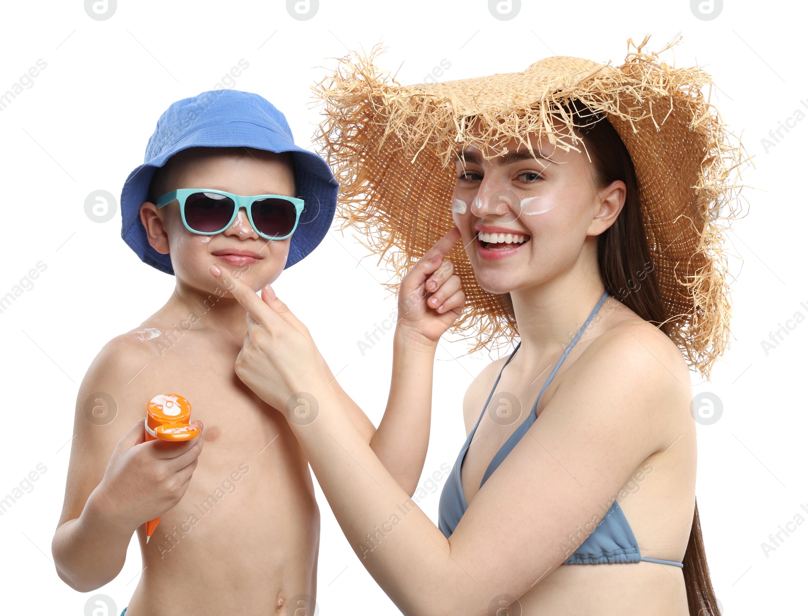 Mother and her son applying sun protection cream onto each other's skin on white background Photo of Mother and her son applying sun protection cream onto each other's skin on white background