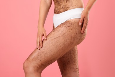 Photo of Woman with body scrub on her skin against pink background, closeup