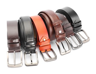 Photo of Many different leather belts isolated on white