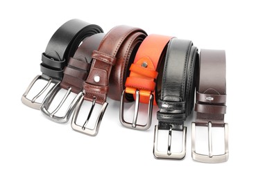 Photo of Many different leather belts isolated on white