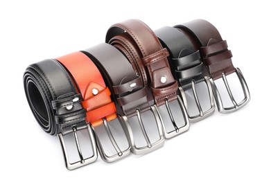 Photo of Many different leather belts isolated on white