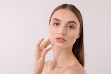 Photo of Portrait of attractive young woman on white background