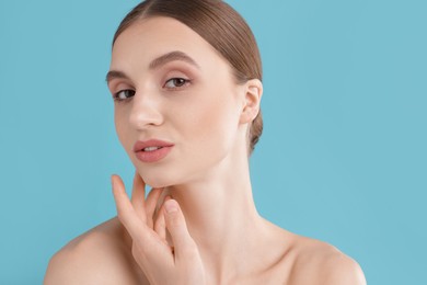 Photo of Portrait of charming young woman on light blue background