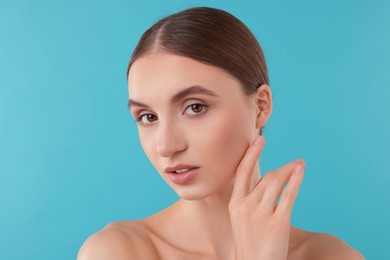 Photo of Portrait of charming young woman on light blue background