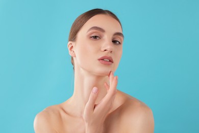 Photo of Portrait of charming young woman on light blue background