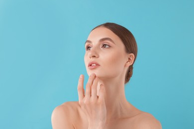 Photo of Portrait of charming young woman on light blue background
