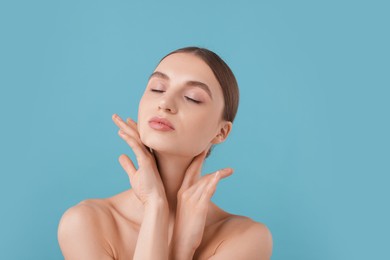Photo of Portrait of charming young woman on light blue background