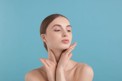 Photo of Portrait of charming young woman on light blue background