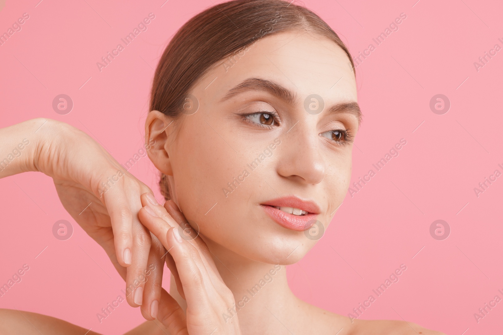 Portrait of beautiful young woman on pink background Photo of Portrait of beautiful young woman on pink background