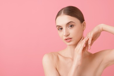 Photo of Portrait of beautiful young woman on pink background. Space for text