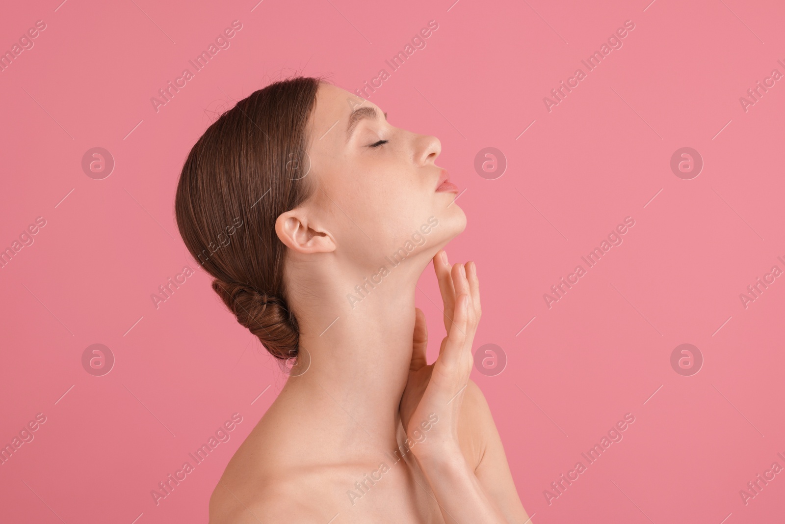 Portrait of beautiful young woman on pink background Photo of Portrait of beautiful young woman on pink background