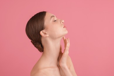Photo of Portrait of beautiful young woman on pink background