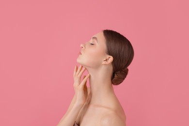 Photo of Portrait of beautiful young woman on pink background