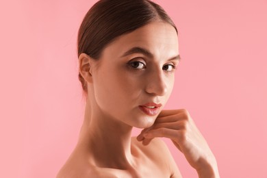 Photo of Portrait of beautiful young woman on pink background