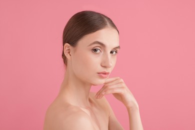 Photo of Portrait of beautiful young woman on pink background