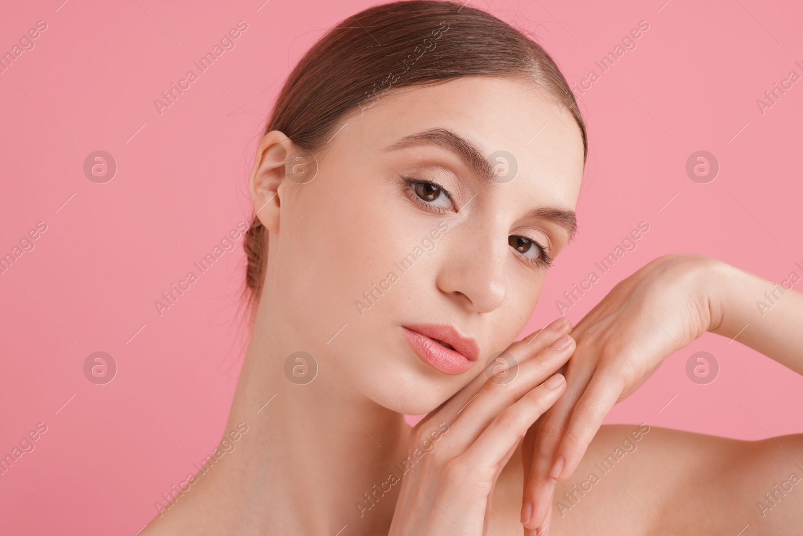 Portrait of beautiful young woman on pink background Photo of Portrait of beautiful young woman on pink background