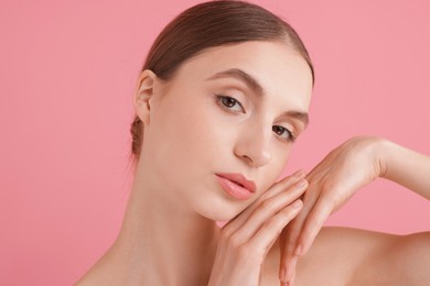 Photo of Portrait of beautiful young woman on pink background