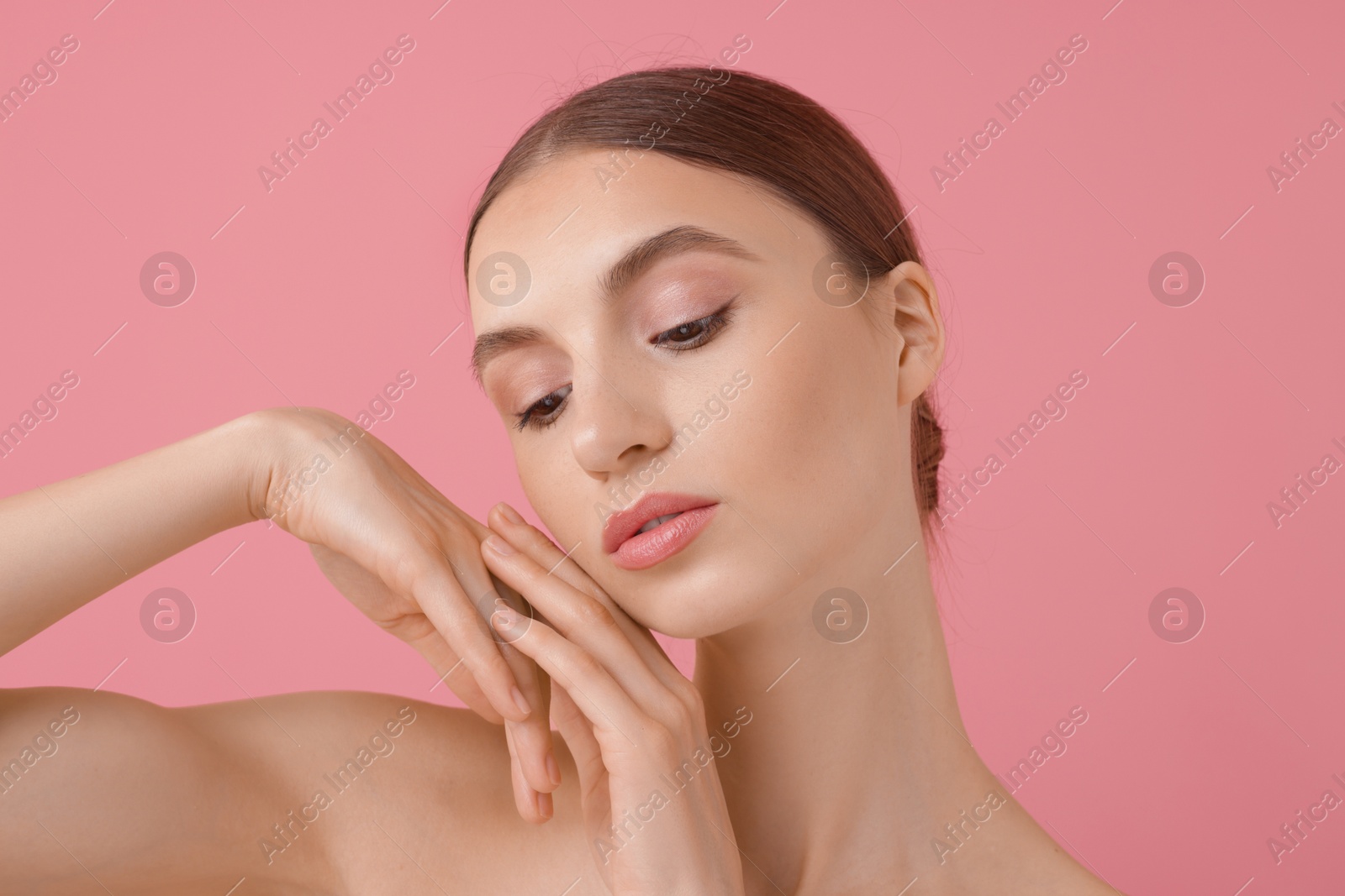 Portrait of beautiful young woman on pink background Photo of Portrait of beautiful young woman on pink background