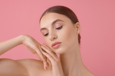 Photo of Portrait of beautiful young woman on pink background