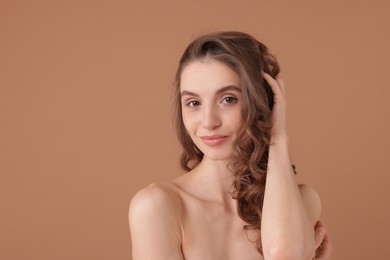 Photo of Portrait of beautiful young woman on beige background