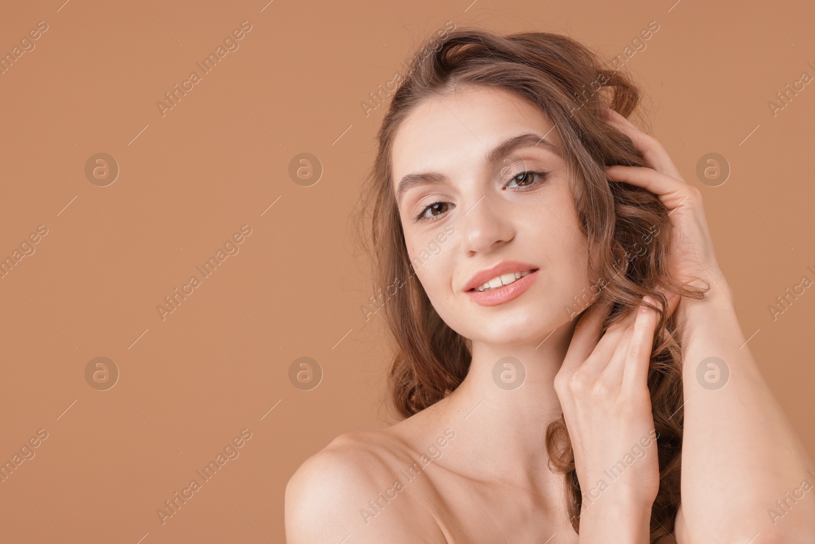 Portrait of beautiful young woman on beige background. Space for text Photo of Portrait of beautiful young woman on beige background. Space for text