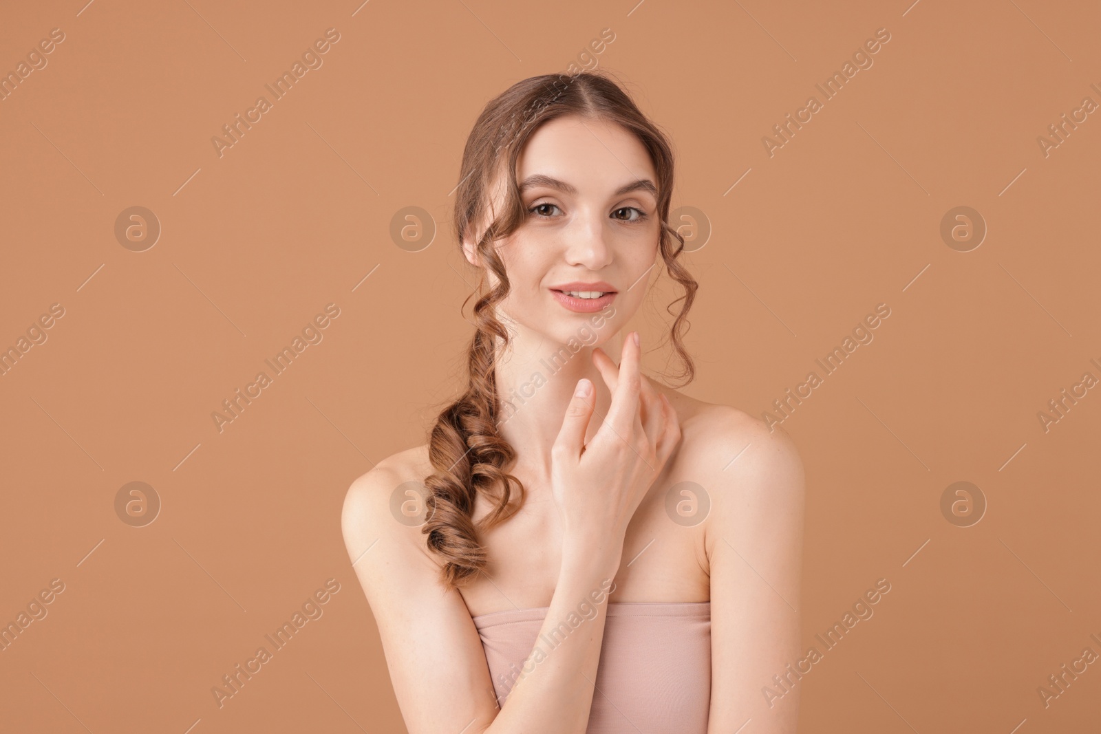 Portrait of beautiful young woman on beige background Photo of Portrait of beautiful young woman on beige background