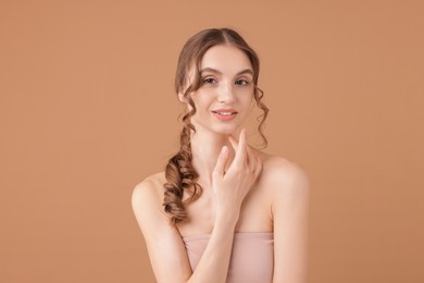 Photo of Portrait of beautiful young woman on beige background