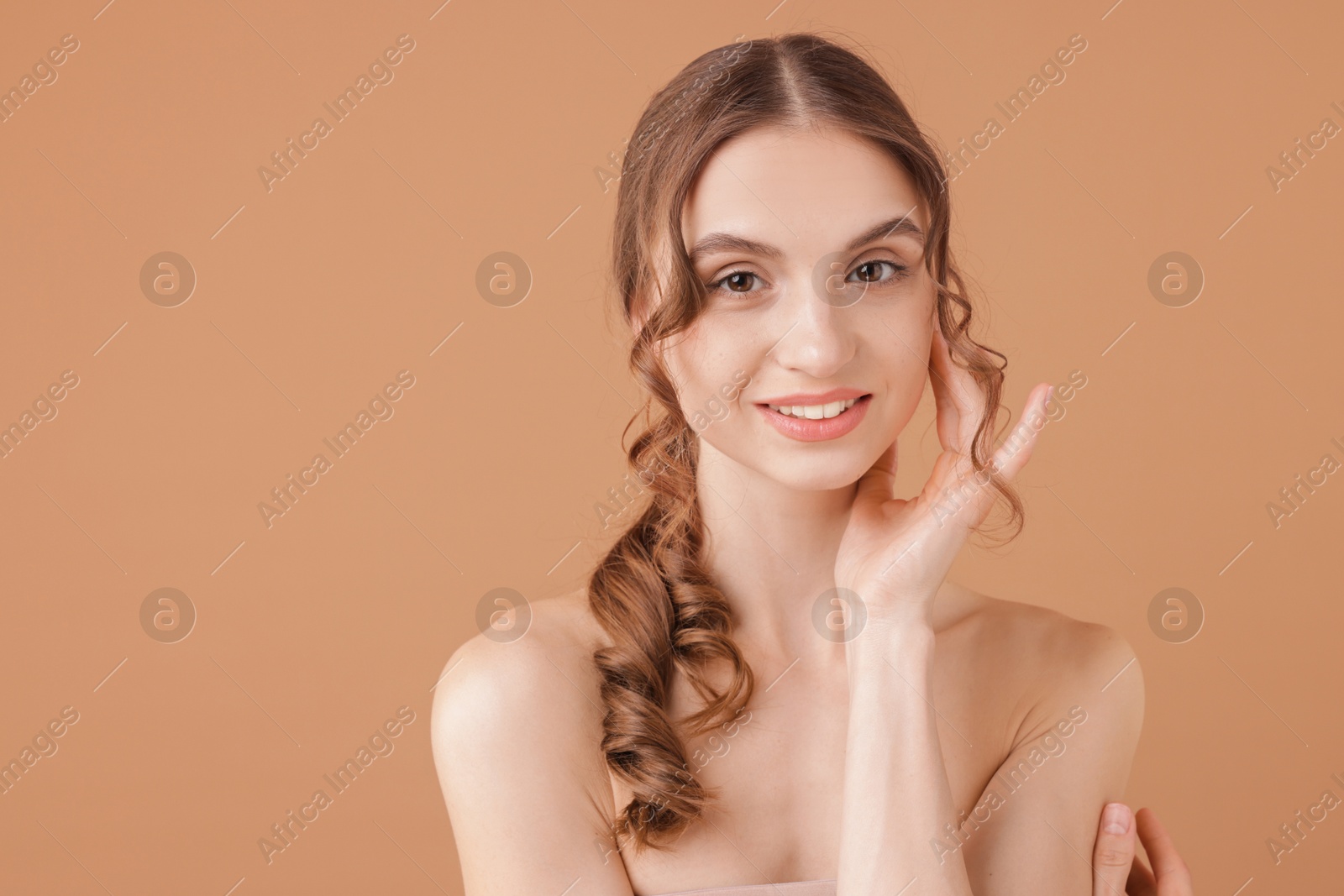 Portrait of beautiful young woman on beige background. Space for text Photo of Portrait of beautiful young woman on beige background. Space for text