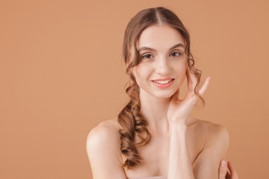 Photo of Portrait of beautiful young woman on beige background. Space for text