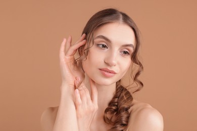 Photo of Portrait of beautiful young woman on beige background