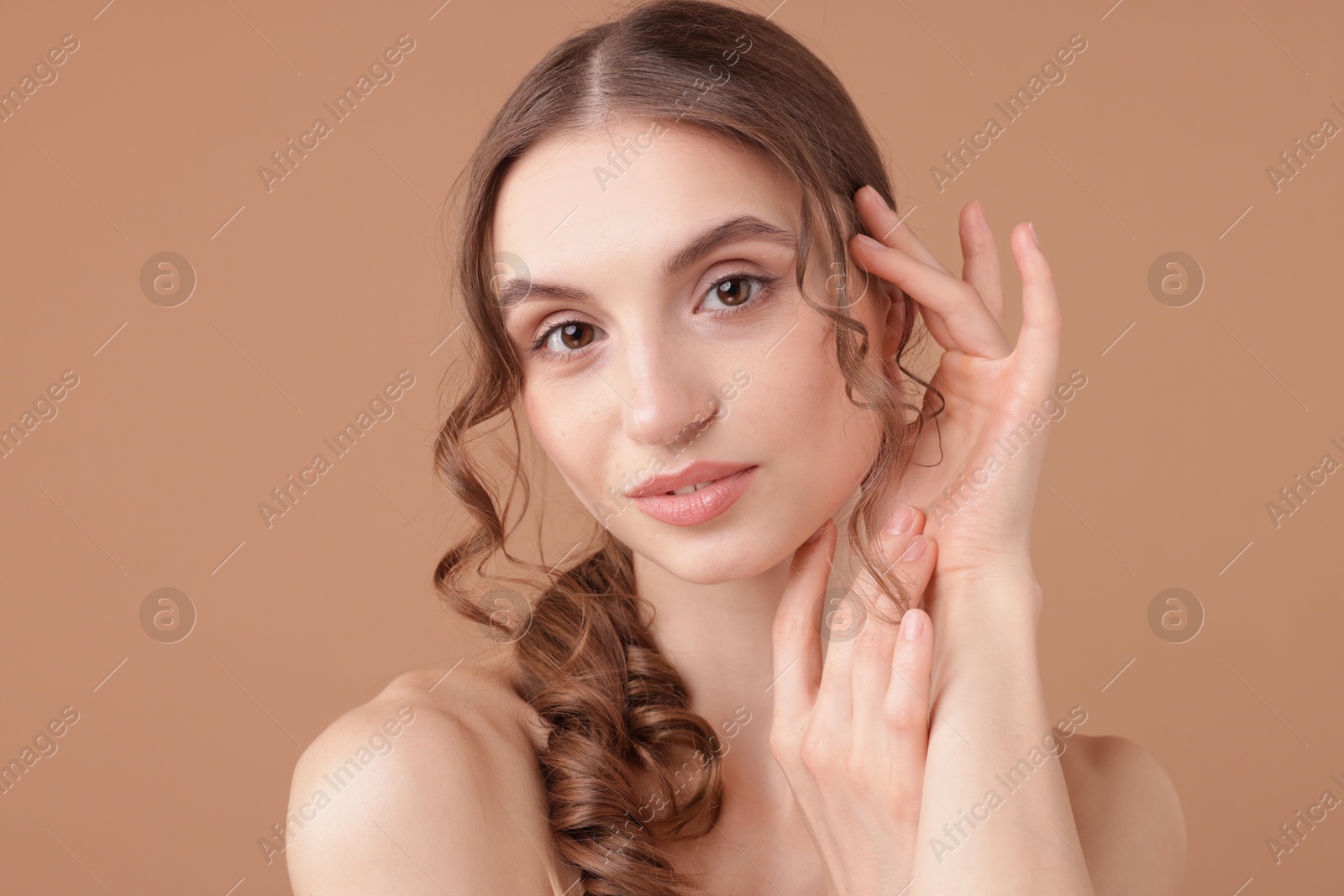 Portrait of beautiful young woman on beige background Photo of Portrait of beautiful young woman on beige background