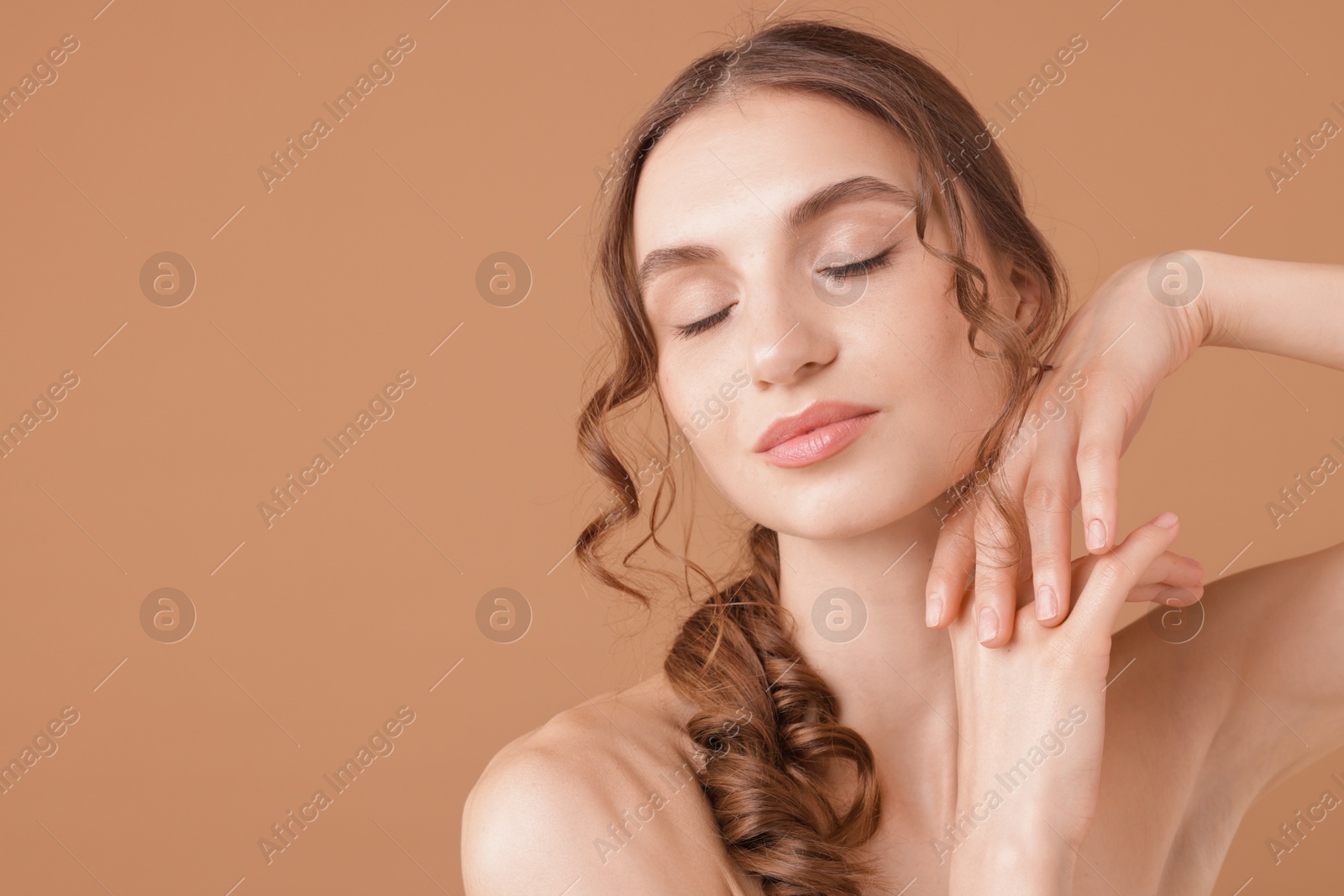 Portrait of beautiful young woman on beige background. Space for text Photo of Portrait of beautiful young woman on beige background. Space for text