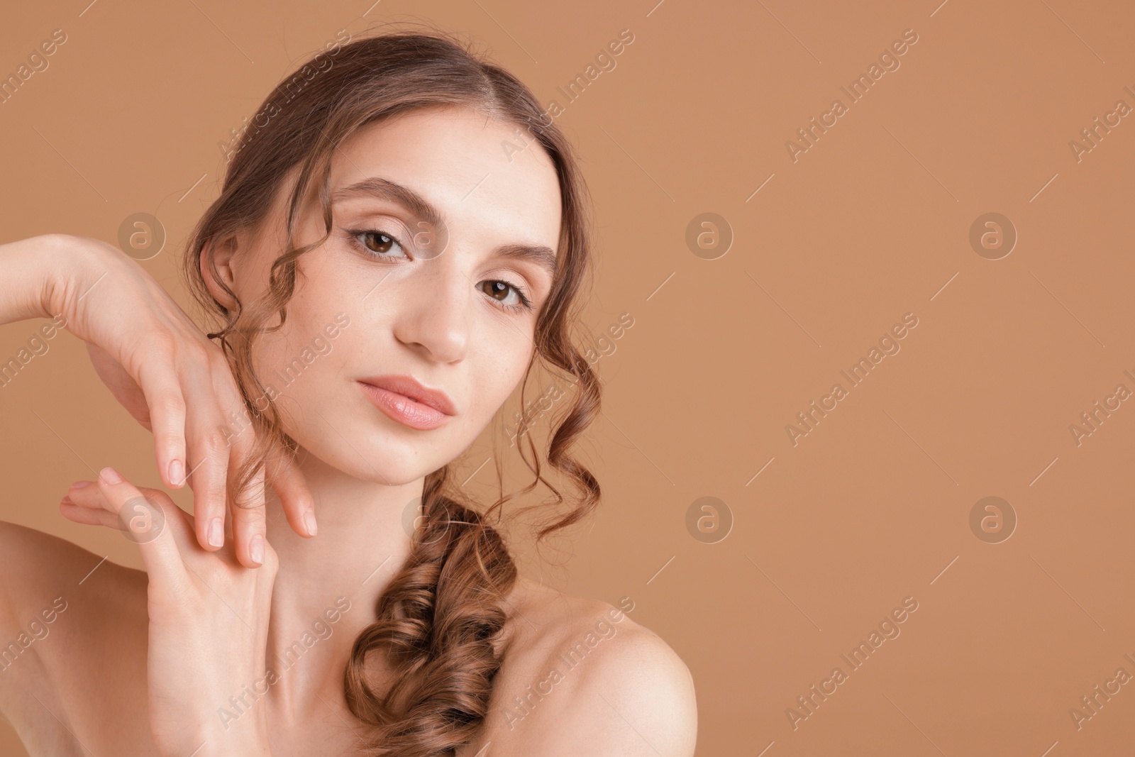 Portrait of beautiful young woman on beige background. Space for text Photo of Portrait of beautiful young woman on beige background. Space for text