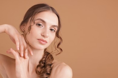 Photo of Portrait of beautiful young woman on beige background. Space for text