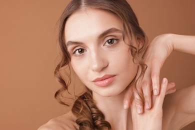 Photo of Portrait of beautiful young woman on beige background