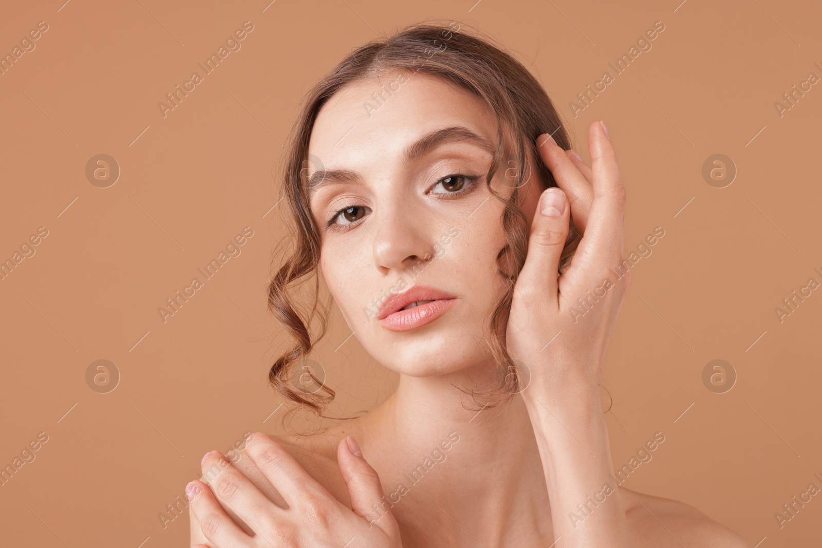 Portrait of beautiful young woman on beige background Photo of Portrait of beautiful young woman on beige background