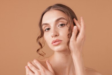 Photo of Portrait of beautiful young woman on beige background
