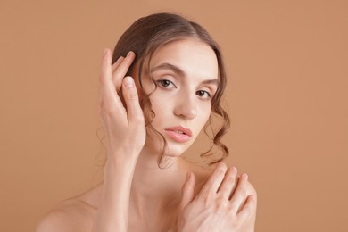 Photo of Portrait of beautiful young woman on beige background