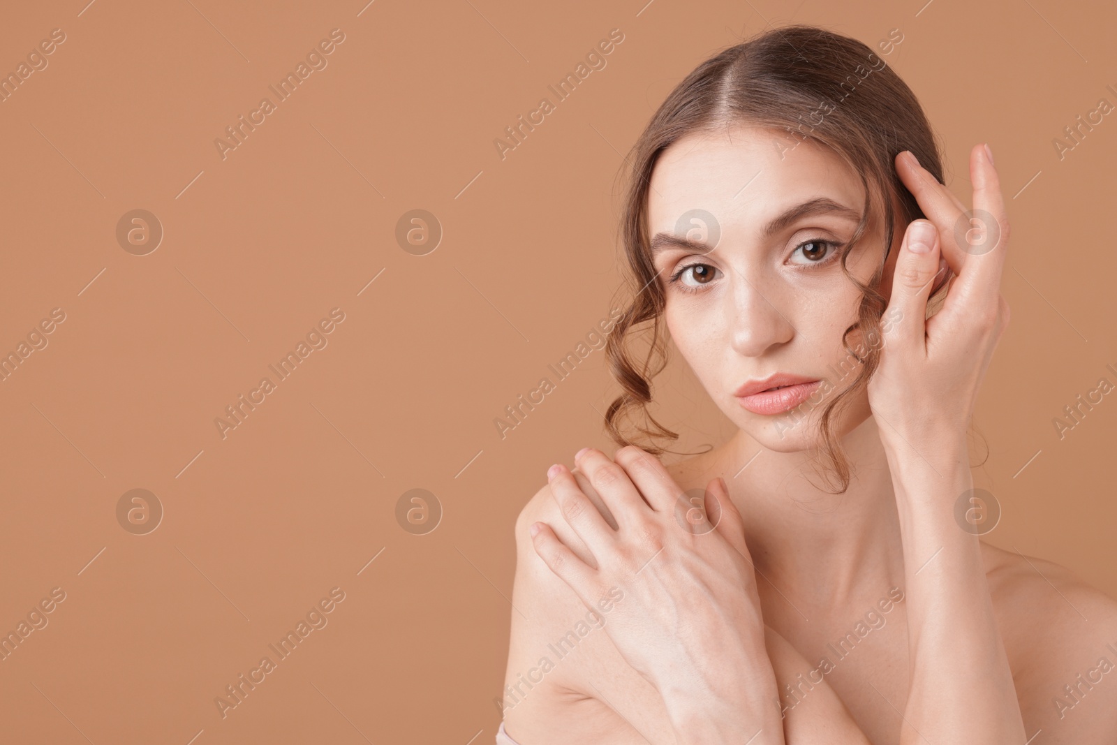 Portrait of beautiful young woman on beige background. Space for text Photo of Portrait of beautiful young woman on beige background. Space for text