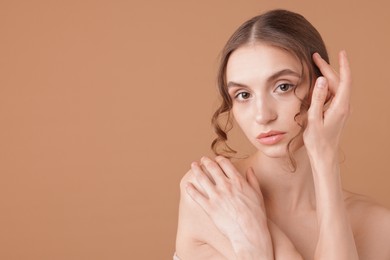 Photo of Portrait of beautiful young woman on beige background. Space for text