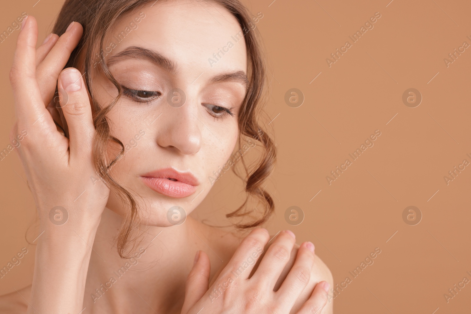 Portrait of beautiful young woman on beige background. Space for text Photo of Portrait of beautiful young woman on beige background. Space for text