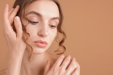 Photo of Portrait of beautiful young woman on beige background. Space for text