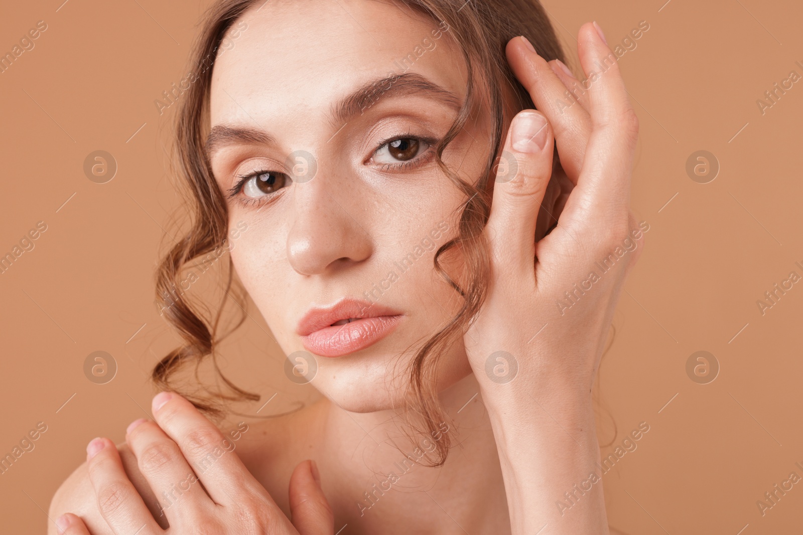 Portrait of beautiful young woman on beige background Photo of Portrait of beautiful young woman on beige background