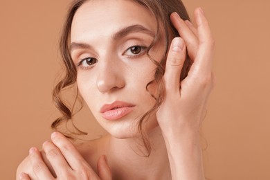 Photo of Portrait of beautiful young woman on beige background