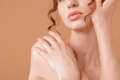 Photo of Beautiful woman posing on beige background, closeup