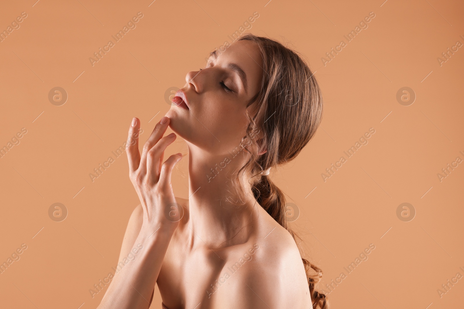 Portrait of beautiful young woman on beige background Photo of Portrait of beautiful young woman on beige background