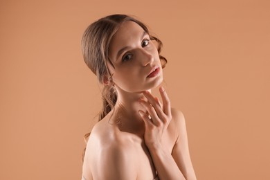 Photo of Portrait of beautiful young woman on beige background