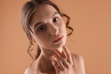 Photo of Portrait of beautiful young woman on beige background