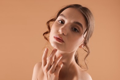 Photo of Portrait of beautiful young woman on beige background